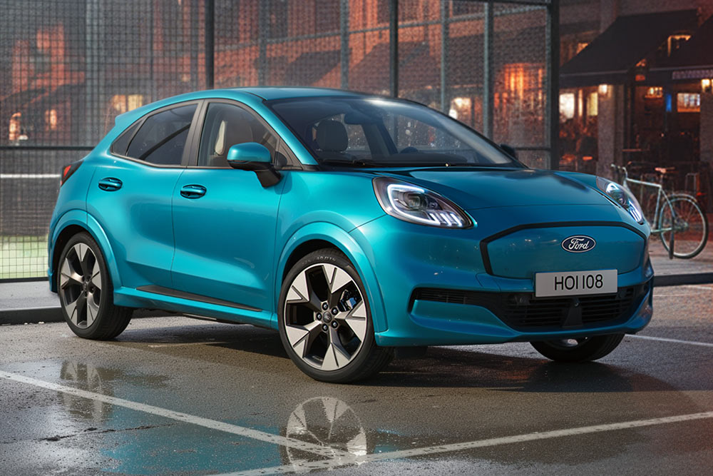 Ford Puma Gen-E garé sur un parking à côté d'un terrain de sport
