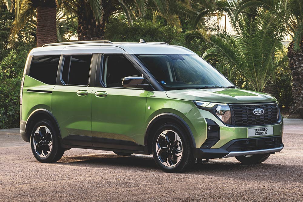 Ford Transit Courier garé devant un immeuble de bureaux.