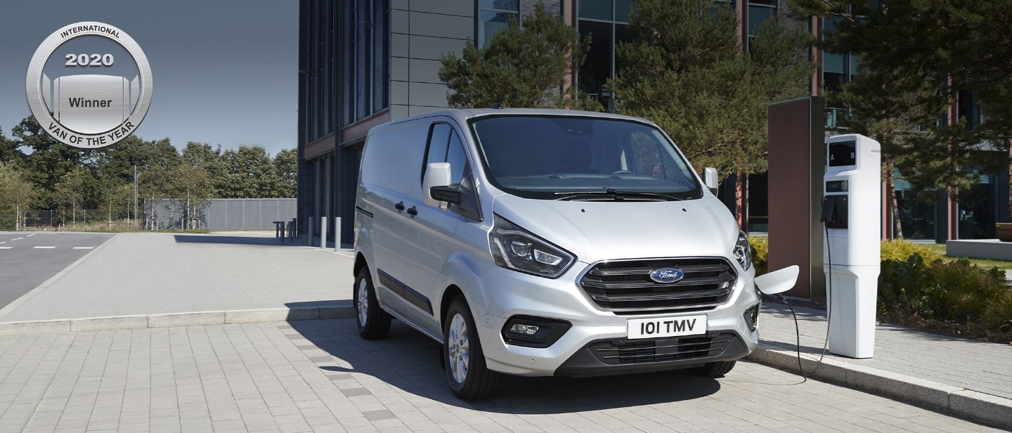 Grey Ford Transit Custom Plug In Hybrid charging in public