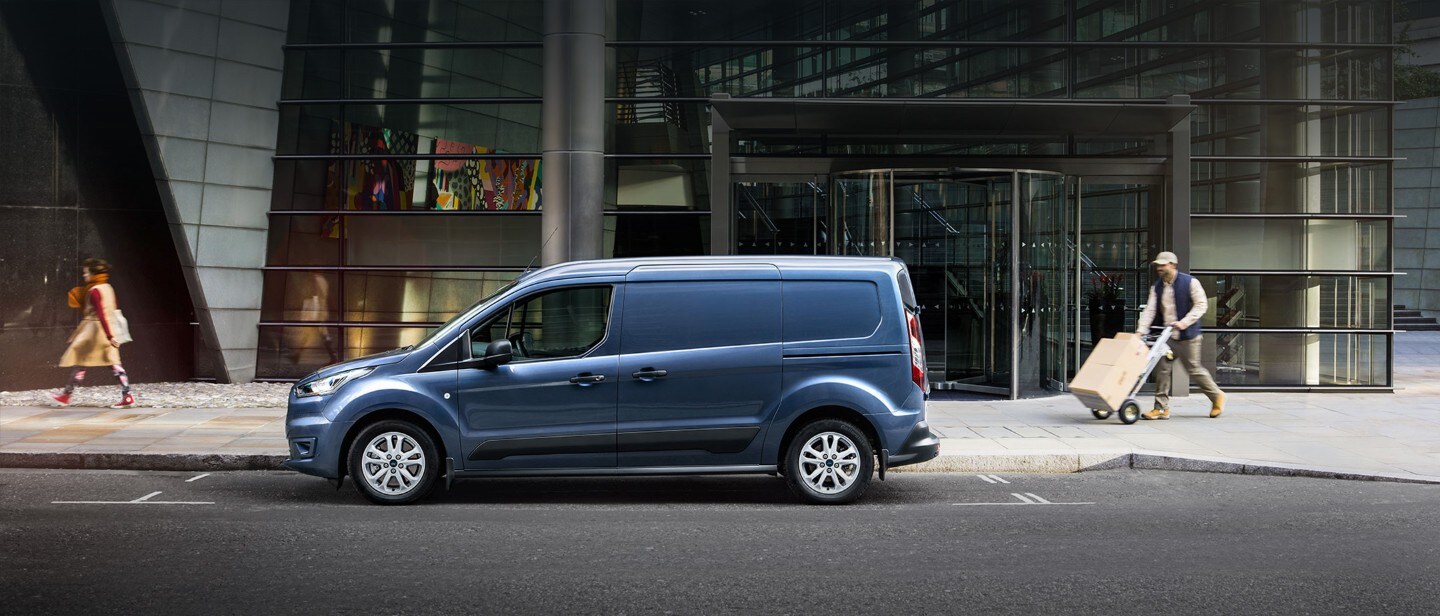New Blue Ford Transit Connect driving in city New Blue Ford Transit Connect driving in city