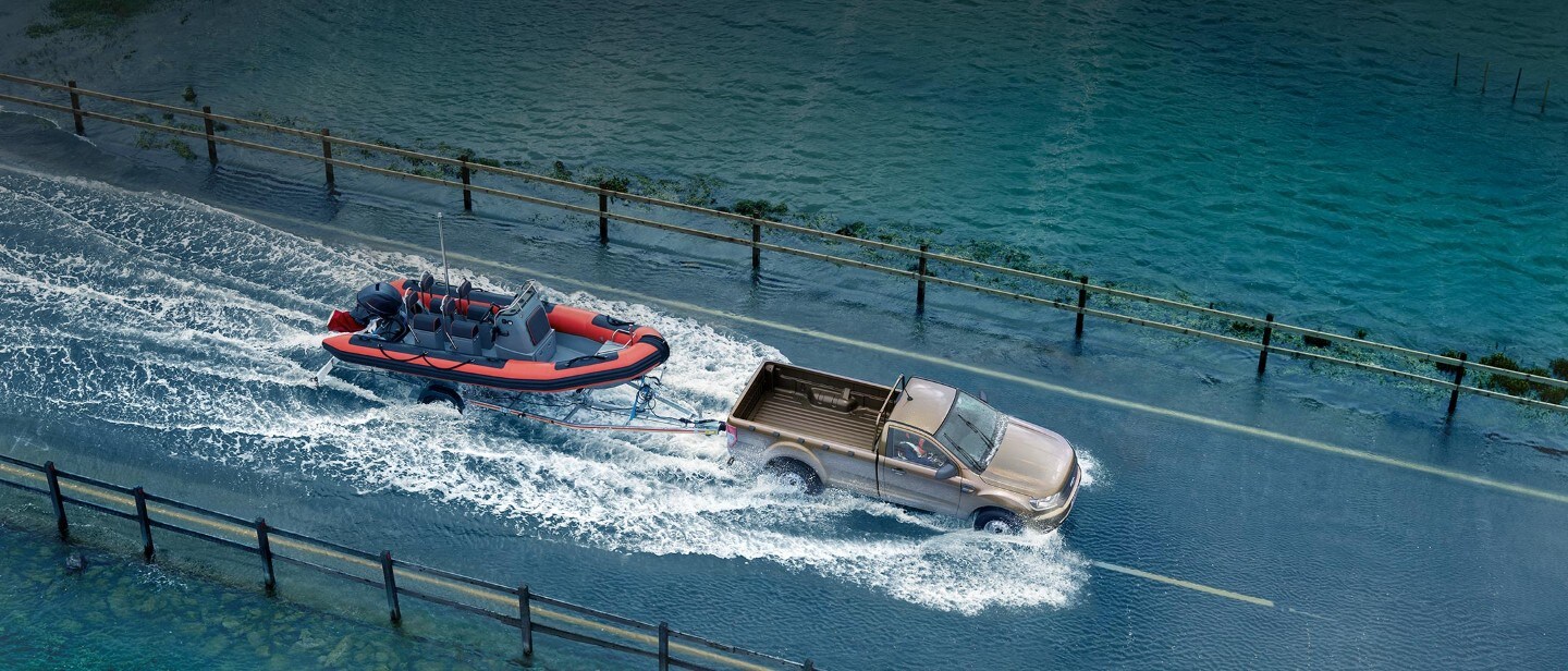New Ford Ranger Regular Cab towing a boat in water