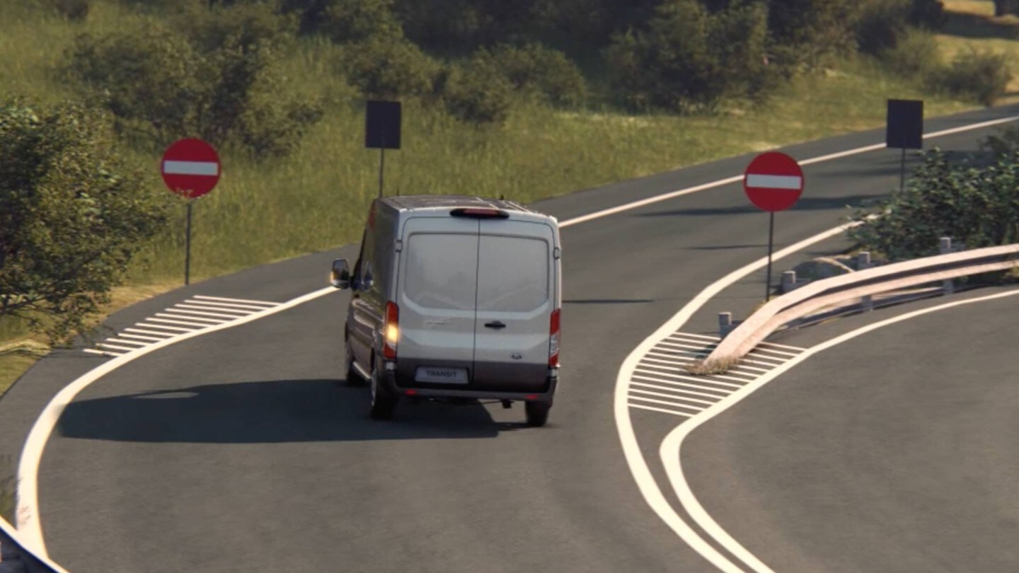 Ford Transit Fourgon couleur argent, vue arrière, freinant devant des panneaux «Accès interdit»