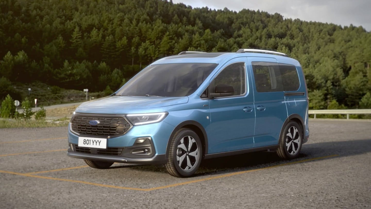 Blue Tourneo Connect parked against a countryside background. 