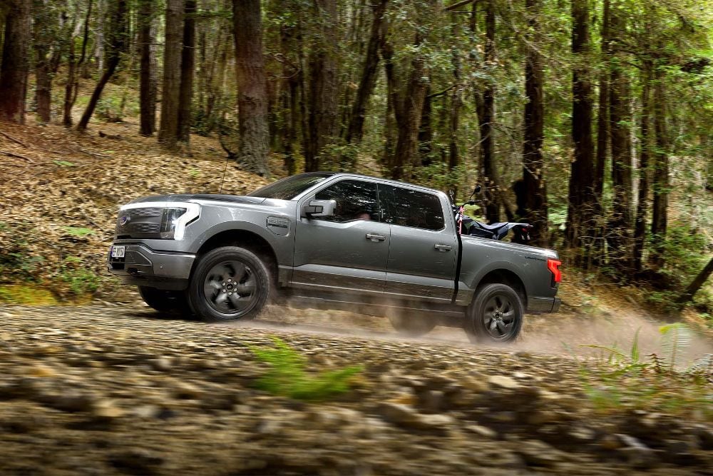 Ford F-150 Lightning driving on forest road