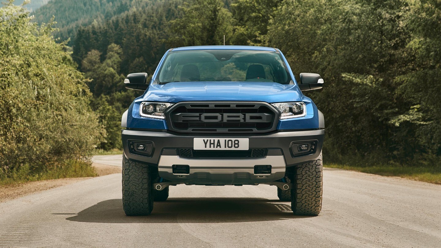 Blue Ford Ranger Raptor parked, front grill view
