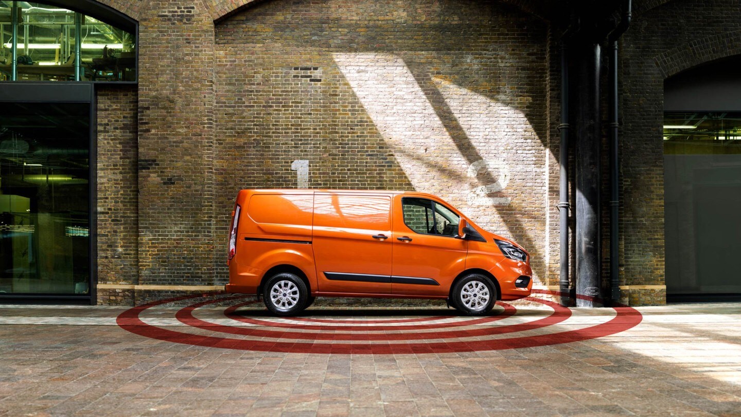Ford Transit Custom couleur orange, vue latérale, illustration de l’alarme antivol